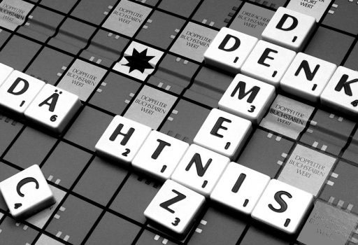 Spielsteine mit Buchstaben auf einem Brett, gelegt wurde auch das Wort "Demenz"